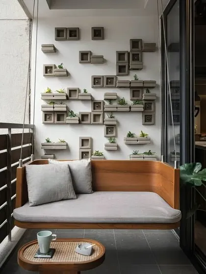 This custom-built wooden swing bench offers a minimalist and sophisticated seating solution. It's paired with a unique wall feature made of concrete planter blocks, blending modern design with natural elements for a truly unique balcony.