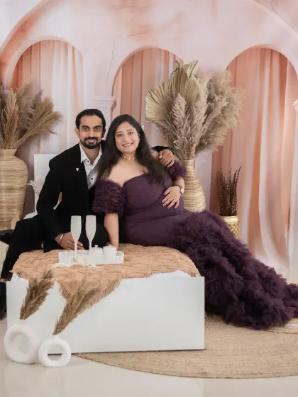 Celebrating the next phase of life with a toast. This setup adds a touch of glamour and celebration to your maternity photoshoot.