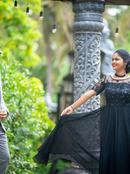 A classic pre-wedding pose in a beautiful garden setting, with the bride's gown adding a touch of elegance.