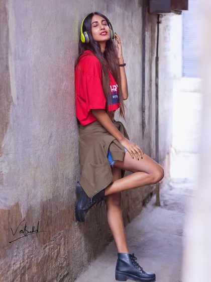 Feeling the music in a quiet city alley. This lifestyle shot is all about capturing a mood, using headphones as a prop to tell a story of personal escape and connection to music.