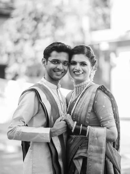 A classic black and white portrait of Kinjal and Siddharth. Holding hands and looking at the camera, their happiness is simple and clear.