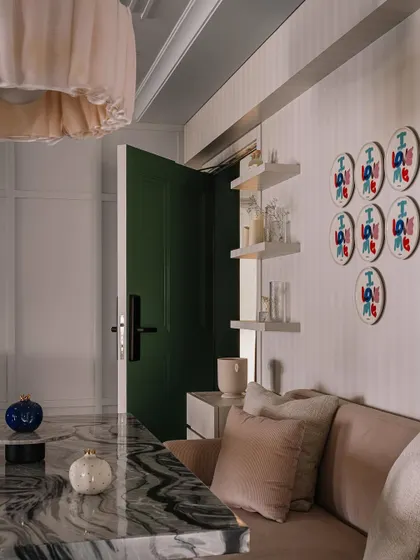 A detail shot from the dining nook, featuring a pop of green on the door and a collection of playful plates on the wall.