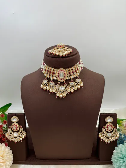 This collection showcases our premium Moissanite Kundan necklaces like the 'Noor Nazaakat' and 'Darbaar' sets. Each comes with a full set of earrings and maang tikka, available in various color combinations.