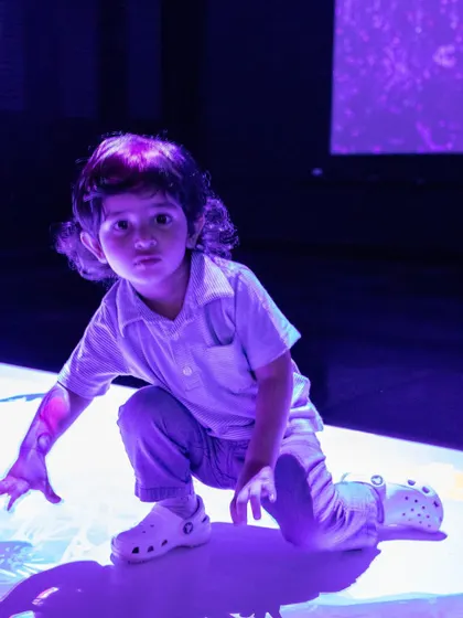 Exploring the magical, light-up floor in our digital play area. It's a sensory experience that captivates children.