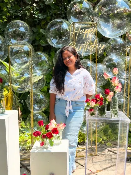 Our founder posing in front of the bubble backdrop. This setup is perfect for outdoor daytime events, as the bubbles catch the sunlight beautifully.