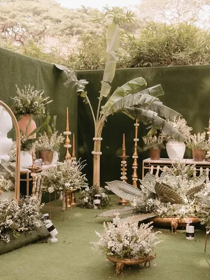 This stunning wedding entrance glows in the warmth of natural tones and grounded elegance. I used banana leaves, white florals, and traditional brass elements to create a serene and organic welcome area.