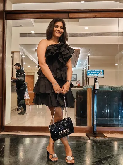 Another look at this ruffled black dress. It's fun to step out of my usual gym wear and dress up.