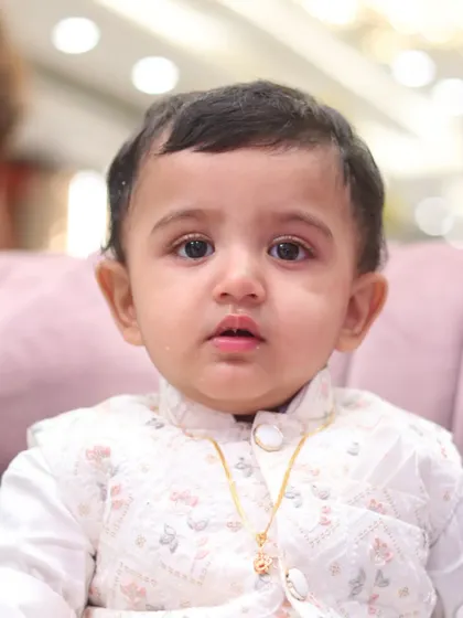 A close-up infant portrait, focusing on the baby's innocent expression and delicate features.