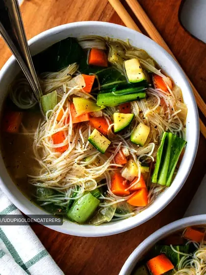 Our vegetable noodle soup is a light and healthy option, featuring thin rice noodles and chunky, fresh vegetables in a clear, savory broth.