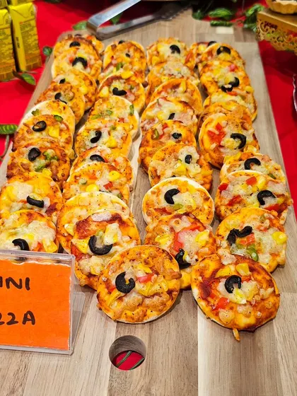 A close-up of our mini pizzas, perfectly arranged on a wooden board for a grazing table. These are always a hit at workshops and launch parties.