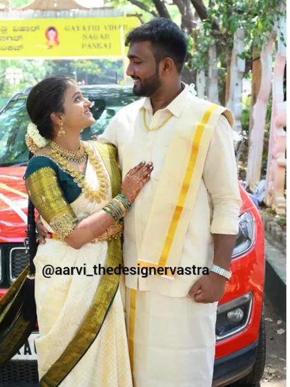 A lovely couple moment. The bride's classic off-white and green saree is perfectly complemented by the groom's traditional veshti and shirt.
