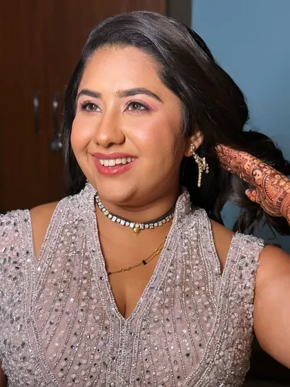 A happy, radiant bride ready for her reception. The makeup is designed to be picture-perfect, with a focus on glowing skin and eyes that sparkle.