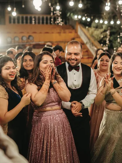 The bride's reaction of pure surprise and joy during the Sangeet is a priceless candid moment we love to capture.