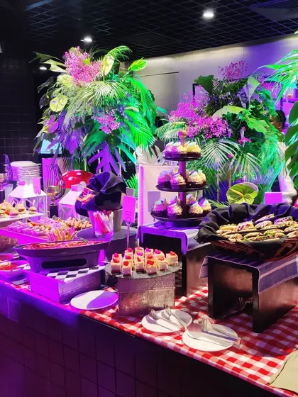 A tropical-themed grazing table we curated for a Spotify event. The setup includes a vibrant mix of fresh bites, desserts, and floral arrangements, creating a fun and immersive atmosphere for guests.