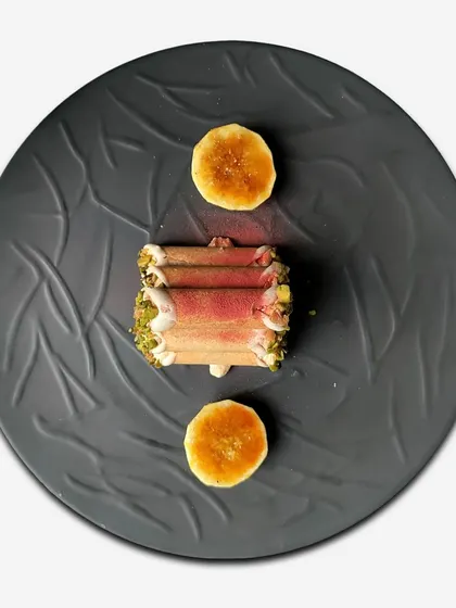 An overhead view of the mishti doi cannoli, a creative fusion of Italian pastry and Bengali sweet, showcasing our playful approach to dessert.