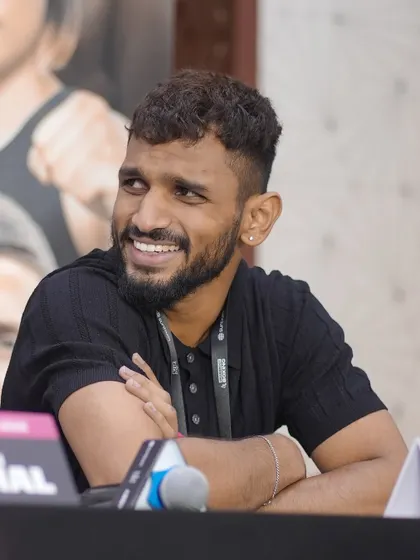 The lighter side of a fighter, sharing a laugh during a press event.