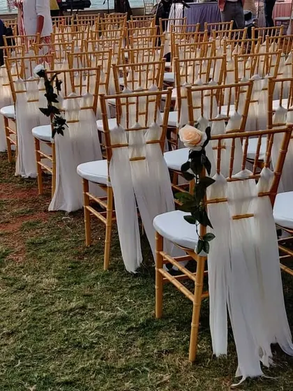 Another option for chair decor, where we added a single, elegant white rose to the draped fabric. It's a small touch that adds a lot of romance.