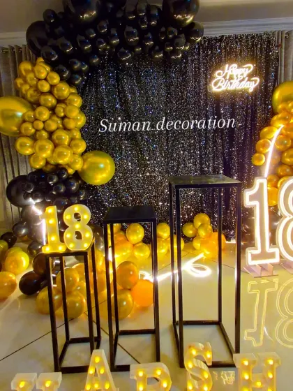 A closer look at the 18th birthday decor, focusing on the marquee numbers and black plinths.