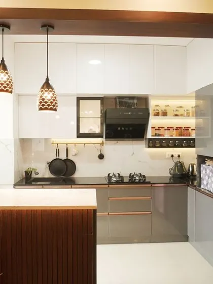 This open-concept kitchen is perfectly integrated with the living and dining areas, featuring a breakfast bar for casual meals. The design includes a beautiful wooden frame that defines the kitchen space without closing it off.