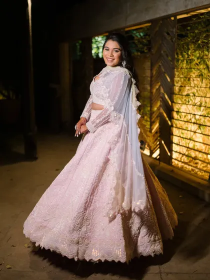 A full-length shot of the bride's stunning pink engagement gown. The look is ethereal and princess-like.