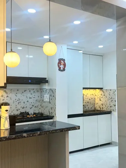 A view of the kitchen showing the cooking area and storage. The design focuses on maximizing counter space and providing ample, easy-to-access storage.