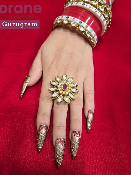 A luxurious set of Karwa Chauth nails with red and gold hand painted chrome work. This is a perfect example of creating custom nails for a traditional Indian festival.