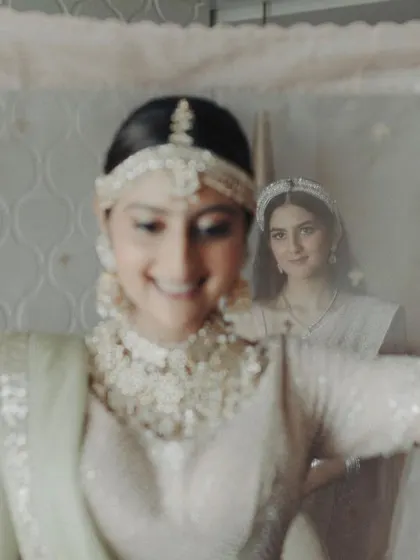 A moment of sisterly love, captured through the bride's veil. The younger sister looks on with admiration as the bride gets ready. I love finding these creative angles to capture intimate family moments that are full of emotion.