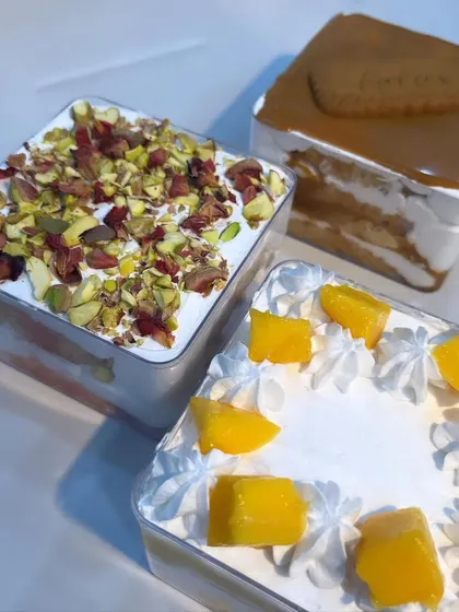 A beautiful shot of my three fusion cake tubs: Rose Pista with pistachios and rose petals, classic Lotus Biscoff, and seasonal Fresh Mango.