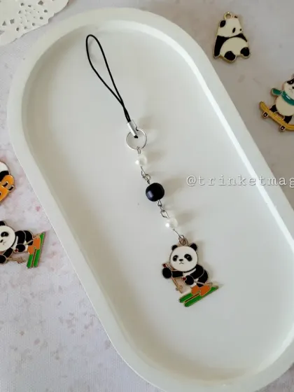 This adorable skiing panda charm is perfect for adding a touch of winter fun to your phone. The black and white design is classic, while the skiing pose is super playful.