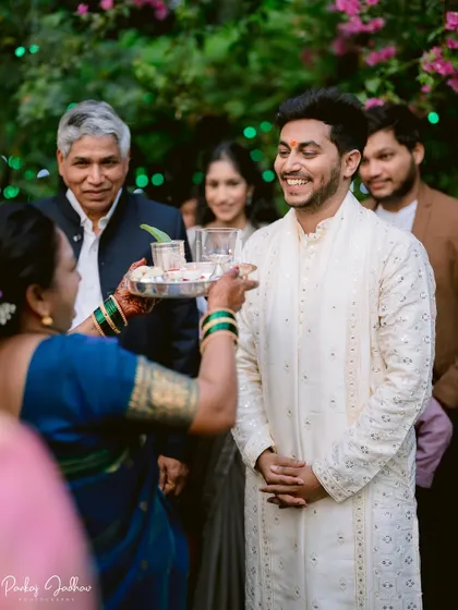 The groom, Abhishek, being welcomed with a traditional aarti during the engagement ceremony.