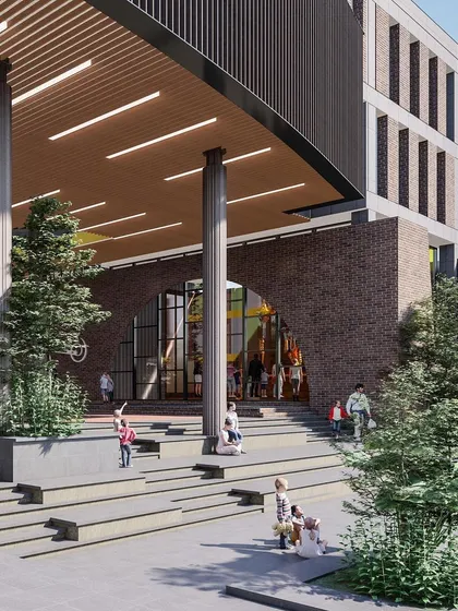 The main entrance of Basil School is designed to feel grand yet approachable for children. The use of warm brick, natural wood tones, and surrounding trees creates a welcoming atmosphere.