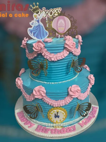 A fairy tale come true, this two-tier princess cake is perfect for a royal birthday. It features Cinderella, a carriage, and beautiful pink and blue details with butterfly accents.