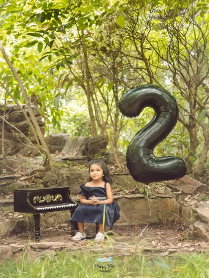 We love getting creative with props for birthday shoots, like this tiny piano that adds a touch of whimsy to her second birthday photos.