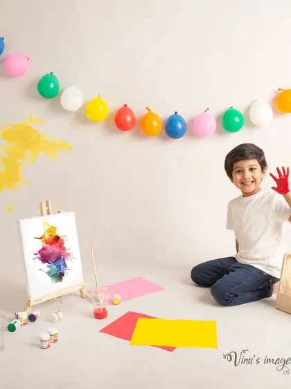 The young artist at work. This portrait captures the older brother enjoying a moment of creativity before the color splash fun begins with his little brother.