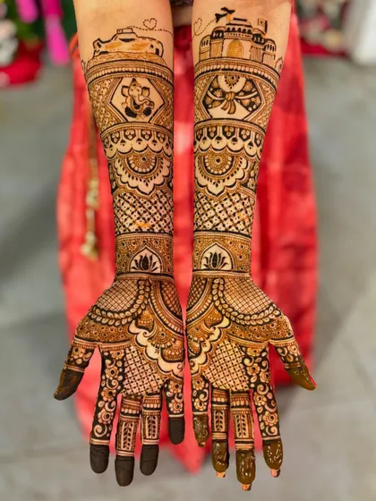 This design tells a story of travel and love, with an airplane flying over the Taj Mahal. It also includes a portrait of Lord Ganesha for blessings.