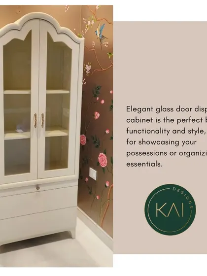 An elegant glass-door display cabinet in a soft white finish. We designed this piece with a classic silhouette to provide a stylish way for our client to showcase their possessions.