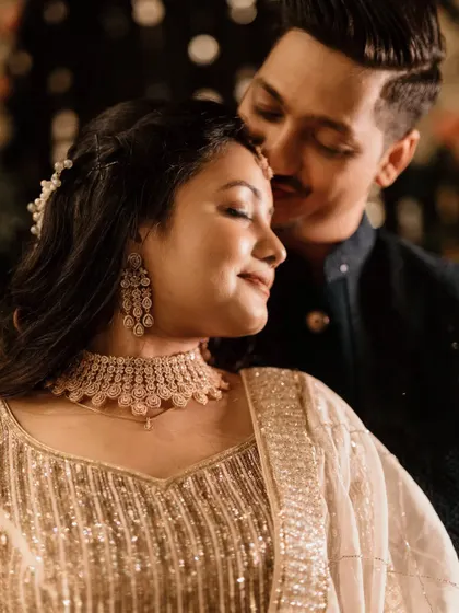 A tender, close-up moment between the couple. His eyes are closed as he rests his forehead against hers, a picture of pure love and contentment.