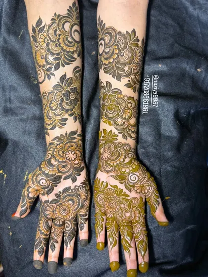 This design shows a stunning contrast between the dark henna paste and the lighter, shaded areas, creating a two-tone effect.