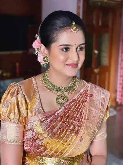 Chandrika looking beautiful for her baby’s naming ceremony. This side profile shows her elegant updo with fresh flowers and her glowing, skin-like makeup.