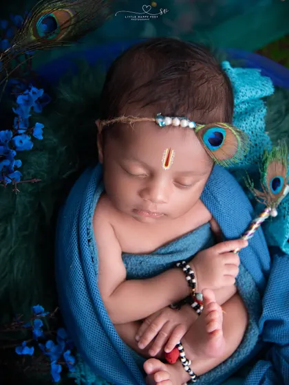 The details make the difference. This close up shot highlights the tiny tilak, the peacock feather headband, and the delicate bracelets, all part of our complete Krishna-themed setup.