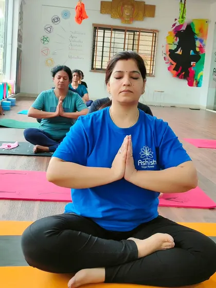 A student in a seated prayer pose, finding her center before the class begins.