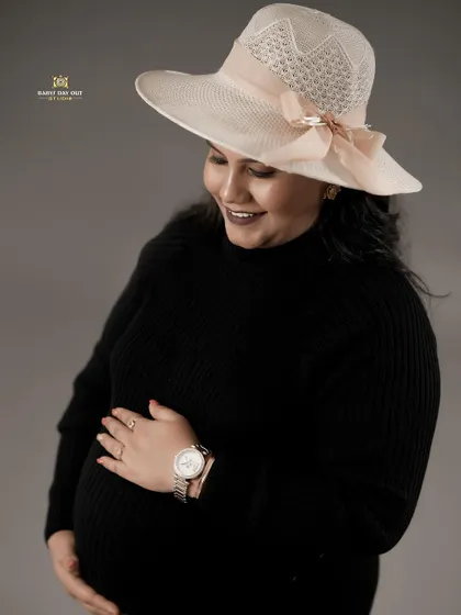 This is a duplicate of image 4. A classic, elegant studio portrait of a mother-to-be, creating a timeless look that focuses on her happy glow.