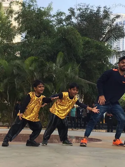 Here I am practicing a routine outdoors with some of my students. I make sure every child gets personal attention so they can learn the steps correctly and perform their best.