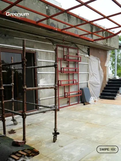 The "before" shot of a terrace wall in Pitampura. This image shows the scaffolding and raw wall before we installed warm wooden paneling and a planter rack.