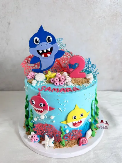 A classic Baby Shark cake with lots of fun details, including coral made from colored white chocolate.