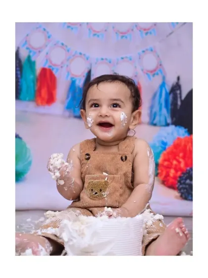 This is the moment it's all about. The pure, unfiltered joy of a first birthday cake smash, with frosting on the hands and the biggest smile. I capture these wonderfully messy memories for you to cherish.