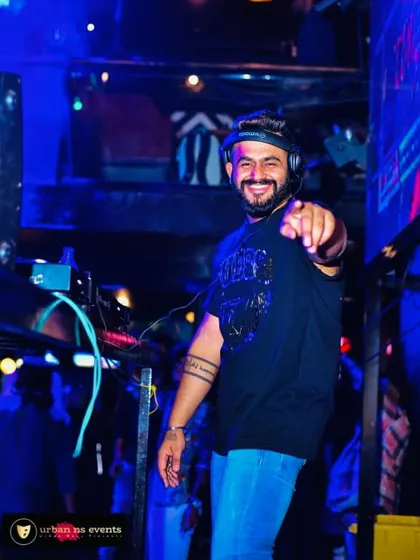 Pointing at you, inviting you to a Neon Night at Gillys 104. Let's make it a night to remember.