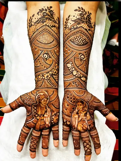 A symmetrical bridal design where portraits of the bride and groom are framed by intricate patterns and topped with bird motifs, creating a balanced and artistic look.