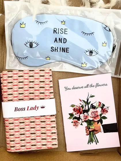 The perfect combination for a boss lady. This set includes a "Rise and Shine" eye mask, a custom-labeled "Boss Lady" journal, and a card that says "You deserve all the flowers."