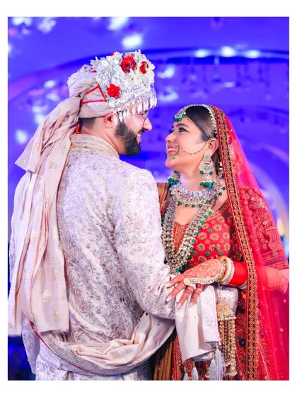 A candid, happy moment between the couple, sharing a look of love and laughter. This image perfectly captures the joy of being newlyweds.